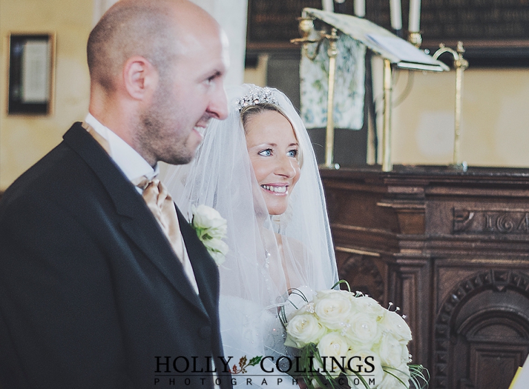Smiling bride saying her vows during wedding ceremony at St Petrox Church, Dartmouth