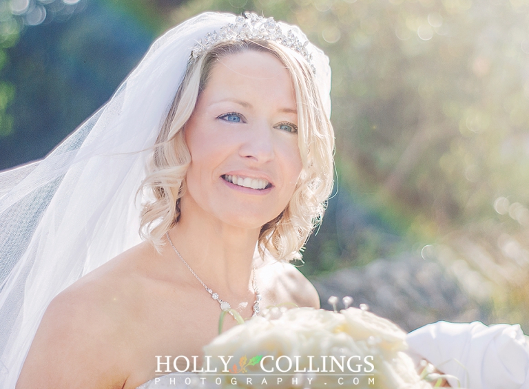 Beautiful bride portrait in sunshine outside St Petrox Church, Dartmouth photographed by Devon Wedding Photographer