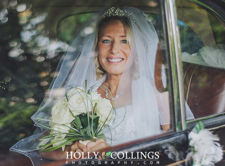 Devon wedding photography of bride arriving in wedding car to St Petrox Church