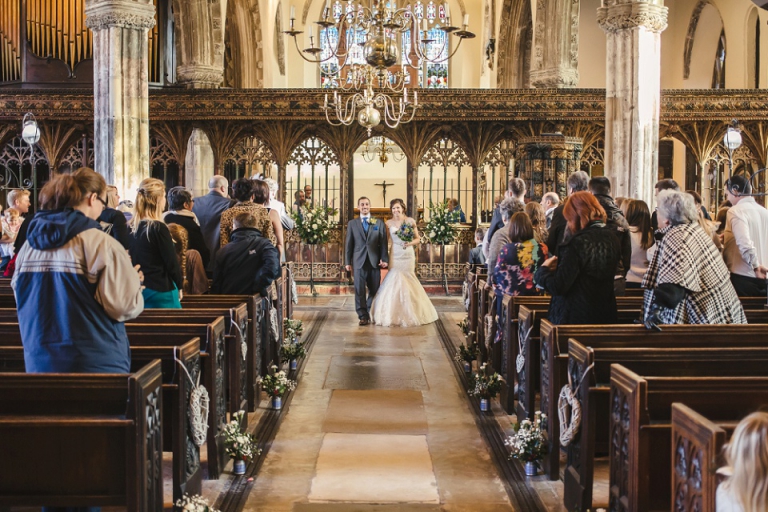 married couple walking down the aisle at st saviours church dartmouth
