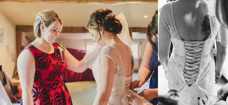 bridesmaid smiling at bride putting on wedding dress while shes being laced up at dartmouth farm