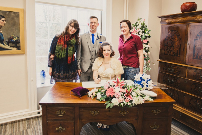 eloped couple with their witness, myself Holly Collings Photography, during their ceremony at cockington court