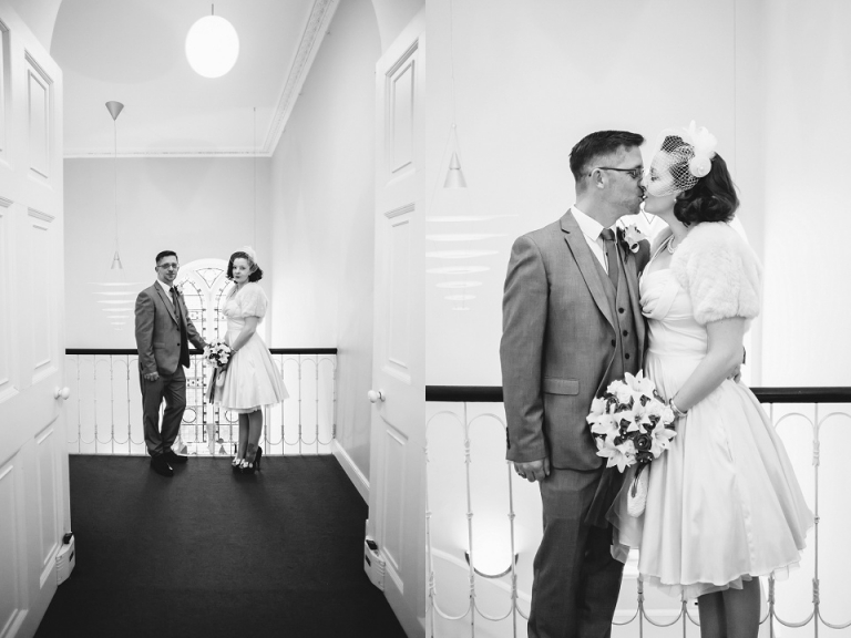 couple portraits after elopement ceremony, at the top of the stairs in front of window, black and white