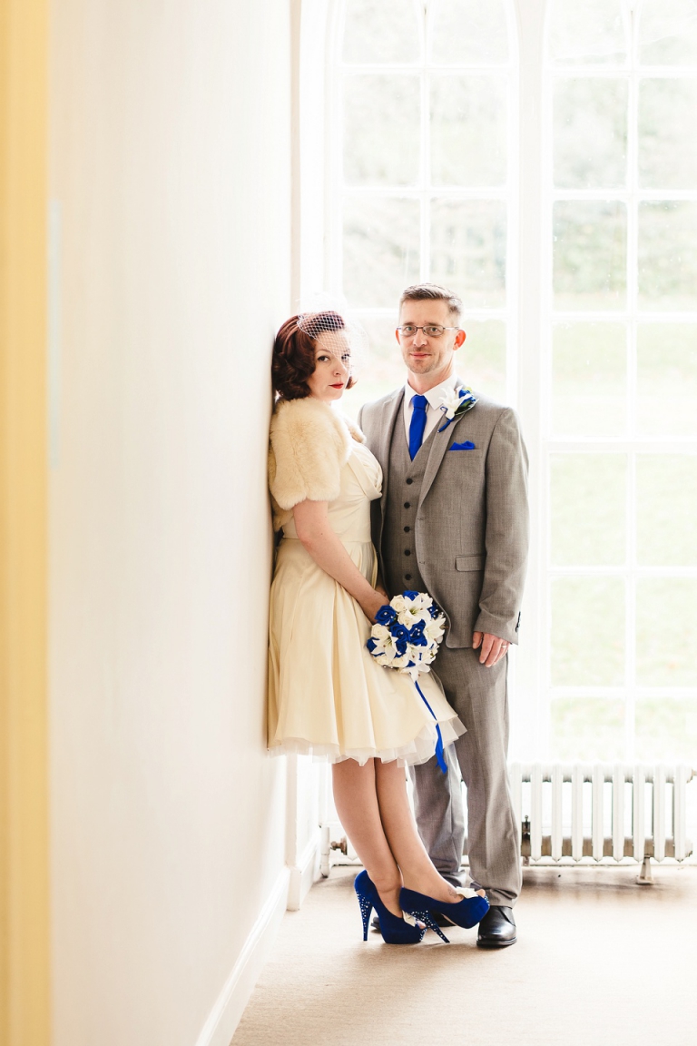 bright modern portrait married couple in front oif sunny window at cockington court torquay