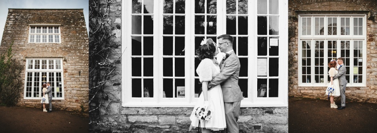 married couple kissing in front on large window at cockington torquay, elopement wedding