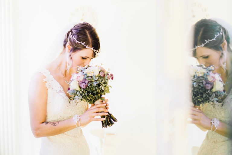 Intimate, Pastel Vintage Wedding Photography at Redcliffe Hotel, Paignton, Devon_bride smelling wild floral designs bouquet reflected in mirror