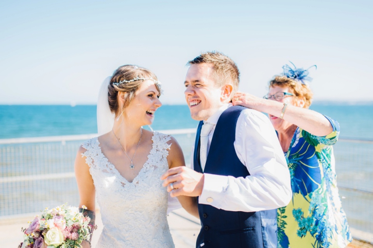 Fun Vintage Wedding Photography at Redcliffe Hotel, Paignton, Devon_friend putting confetti down grooms collar