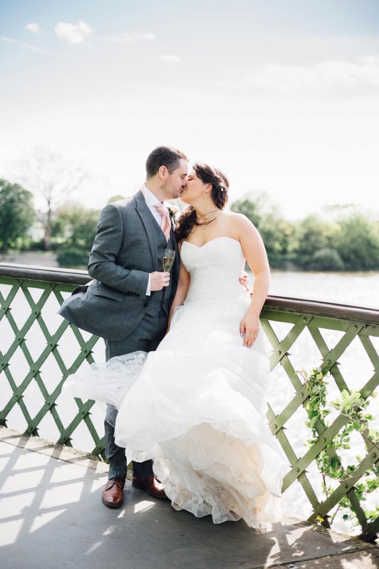 Best of wedding photography in Torquay, Paignton, London and Exeter - Natural, Candid, Photojournalistic couple kissing on hammersmith bridge
