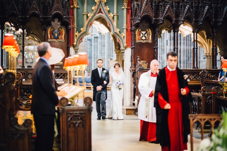 Best of wedding photography in Torquay, Paignton, London and Exeter - Natural, Candid, Photojournalistic bride and groom walking down the aisle for blessing at exeter cathedral