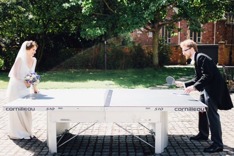 Best of wedding photography in Torquay, Paignton, London and Exeter - Natural, Candid, Photojournalistic - bride and groom playing table tennis outside exeter cathedral