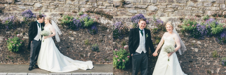 Best of wedding photography in Torquay, Paignton, London and Exeter - Natural, Candid, Photojournalistic couple holding hands in front of flowery old wall