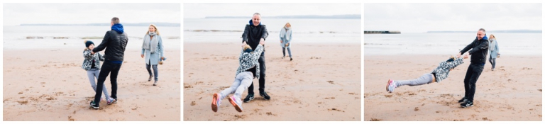 Torre Abbey Sands Torquay Family Photography_dad swinging daughter around on beach