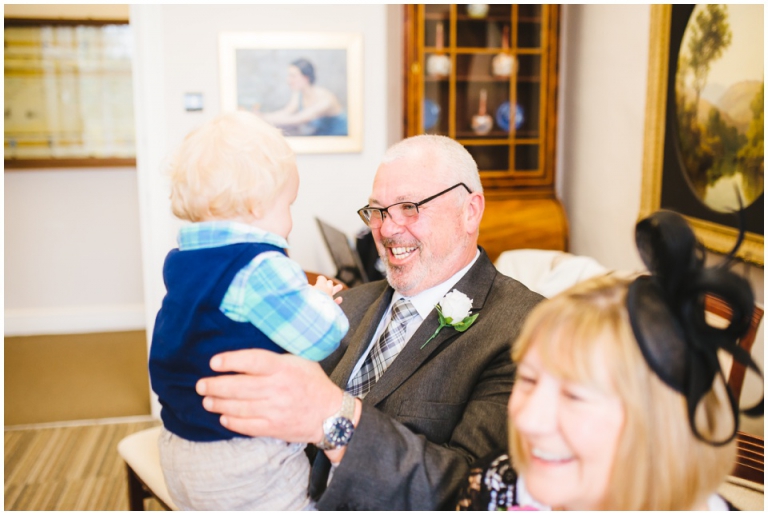 13 Small Intimate Cockington Court Wedding Photography in Torquay - man grinning at grandson