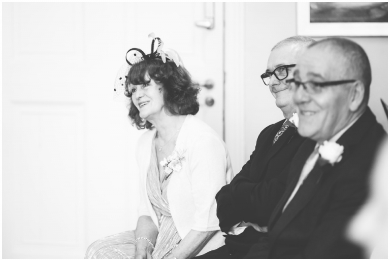 19 Small Intimate Cockington Court Wedding Photography in Torquay - black and white sister smiling in ceremony