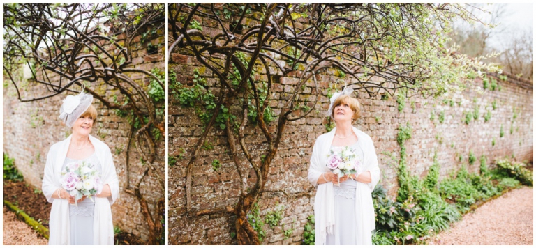 38 Small Intimate Cockington Court Wedding Photography in Torquay - bride in Jacques Vert with Rose Boutique silk flowers in rose garden