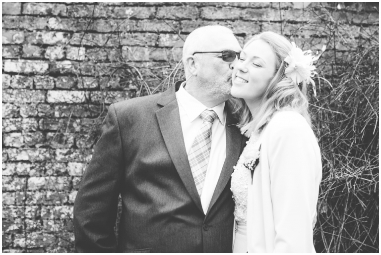 40 Small Intimate Cockington Court Wedding Photography in Torquay - dad kissing daughter on cheek