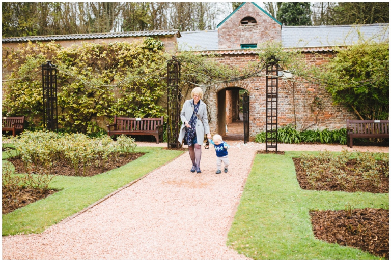 42 Small Intimate Cockington Court Wedding Photography in Torquay - aunt walking with toddler