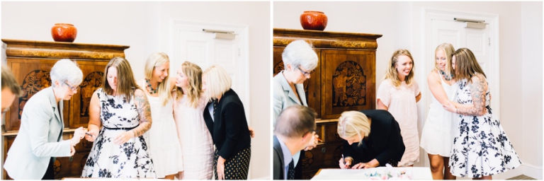 cockington-court-torquay-wedding-photography-documentary-style-12-hugging-signing-the-register