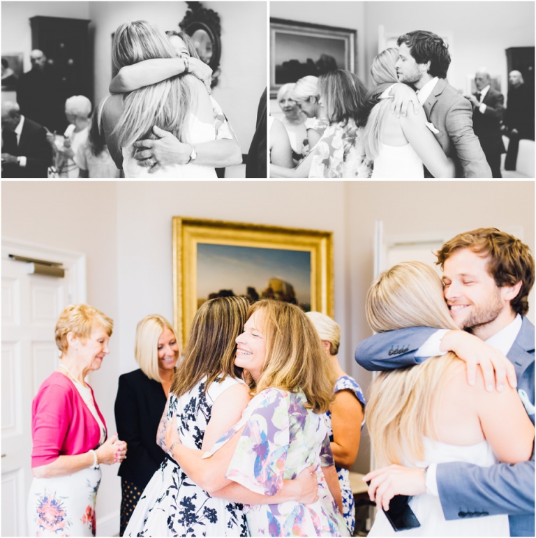 cockington-court-torquay-wedding-photography-documentary-style-15-brides-hugging-family-after-ceremony