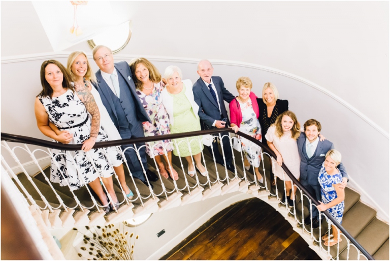 cockington-court-torquay-wedding-photography-documentary-style-16-family-group-portrait-on-the-stairs