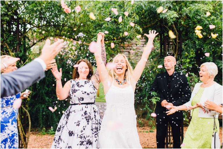 cockington-court-torquay-wedding-photography-documentary-style-18-happy-brides-in-confetti-shower