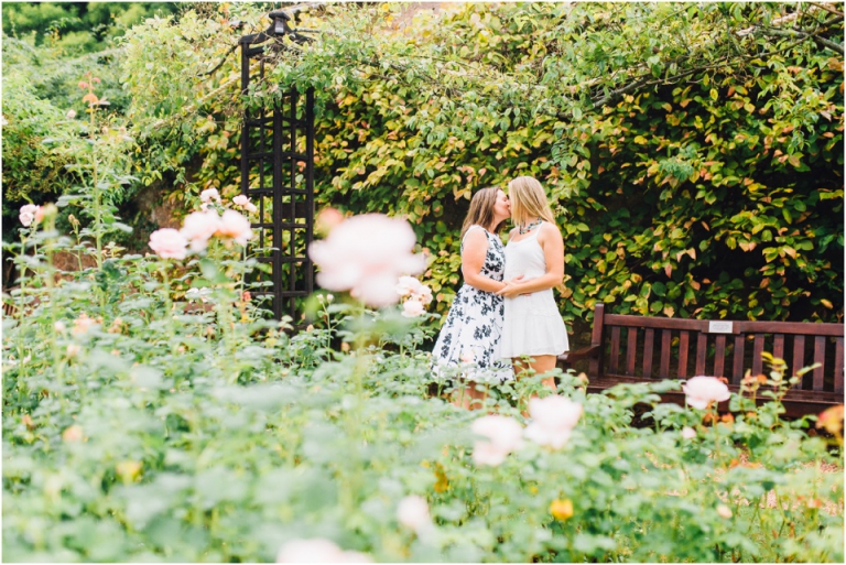 cockington-court-torquay-wedding-photography-documentary-style-22-brides-kiss-rose-garden-natural-couple-portrait