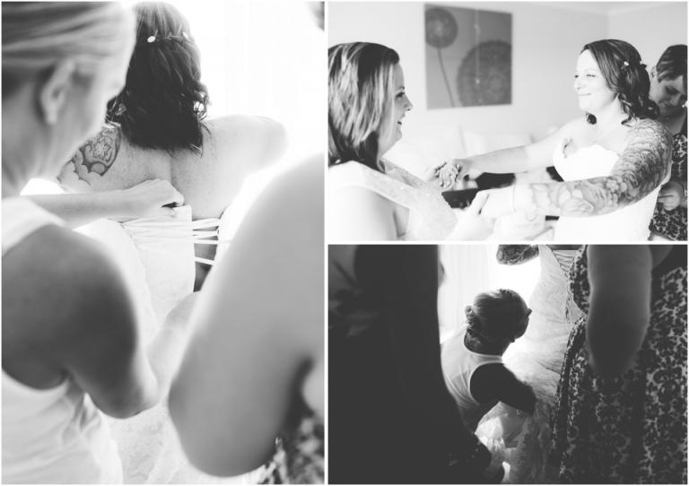 10 Blackpool Sands Dartmouth Wedding Photography Creative Documentary - bride being helped into dress by friends black and white