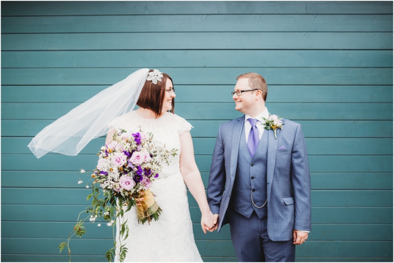 165-best-of-documentary-wedding-photography-in-devon-torquay-exeter-south-west-bride-and-groom-quirky-blue-background-fun-creative