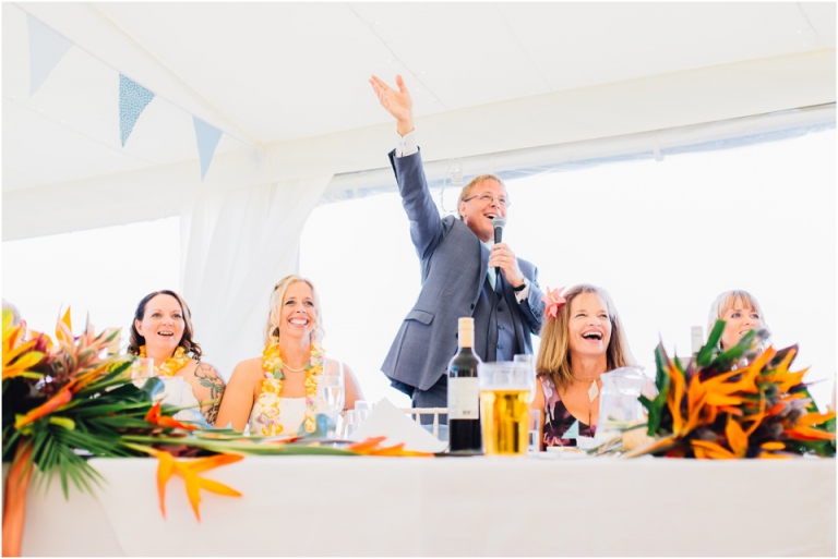 59 Blackpool Sands Dartmouth Wedding Photography Creative Documentary - dad waving in speech, people laughing