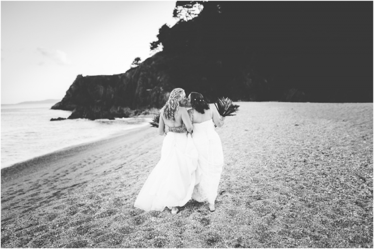 80 Blackpool Sands Dartmouth Wedding Photography Creative Documentary - black and white brides walking on beach kissing