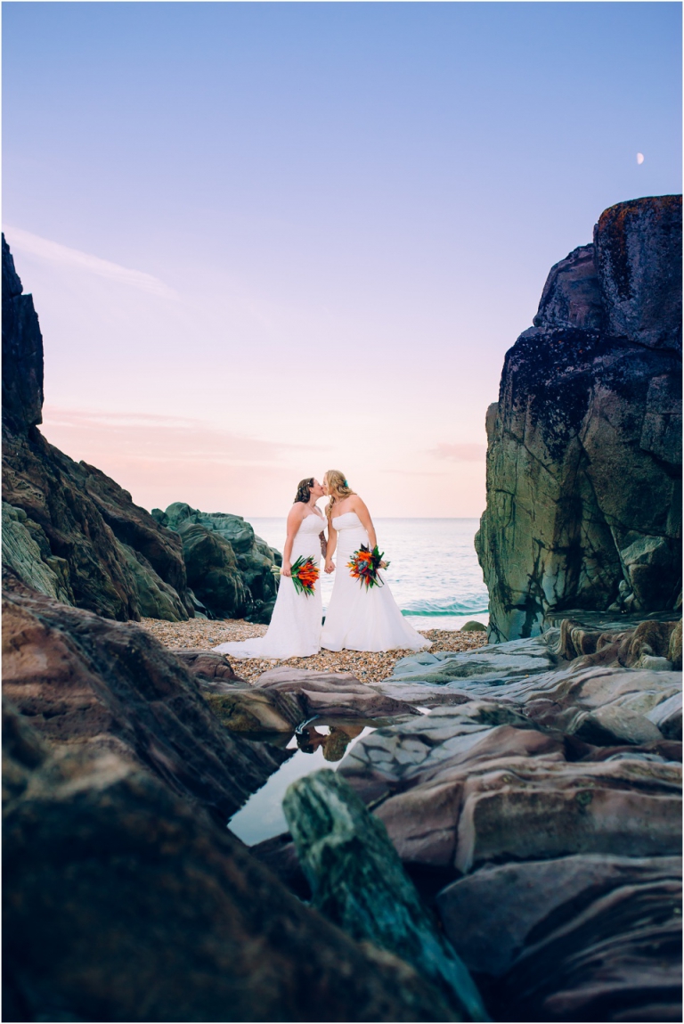 83 Blackpool Sands Dartmouth Wedding Photography Creative Documentary - amazing couple shot brides kissing on rocks by sea