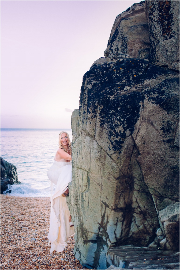 91 Blackpool Sands Dartmouth Wedding Photography Creative Documentary - bride rock climbing