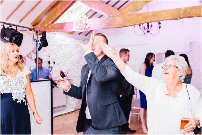 92-best-of-documentary-wedding-photography-in-devon-torquay-exeter-south-west-bouquet-throw-on-dance-floor-funny-candid-capture
