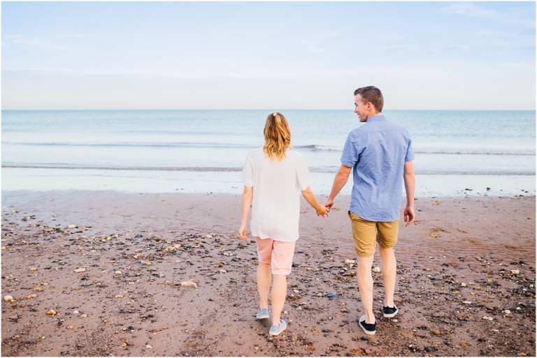1 Dawlish Warren Engagement Couple Photography in Devon - couple walking holding hands on beach