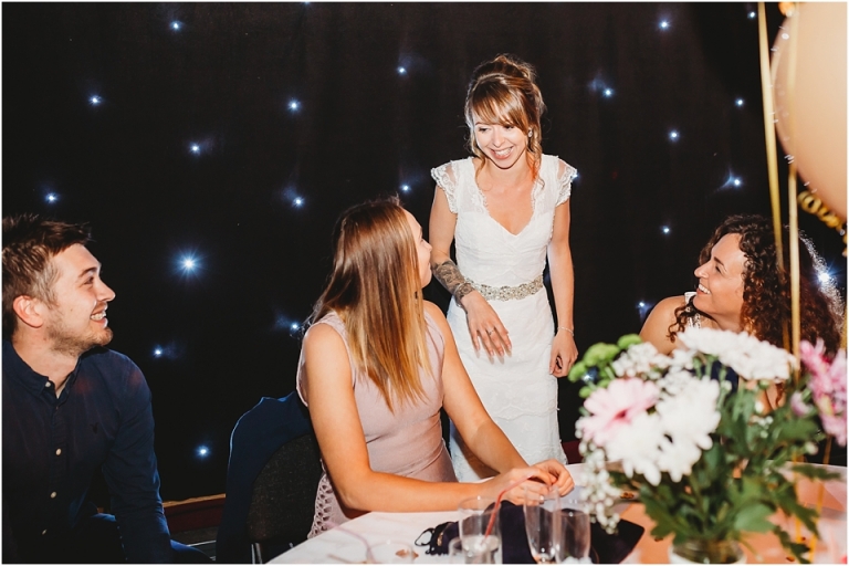 34 Wedding Reception Photography at The Flavel, Dartmouth - bride laughing with guests