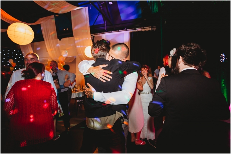 51 Wedding Reception Photography at The Flavel, Dartmouth - friends hugging on dance floor