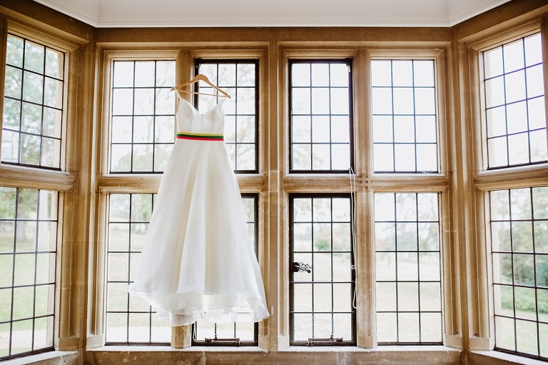 Coombe Lodge Wedding Photography Autumnal Rainbow Styling 2 Dress in window 1